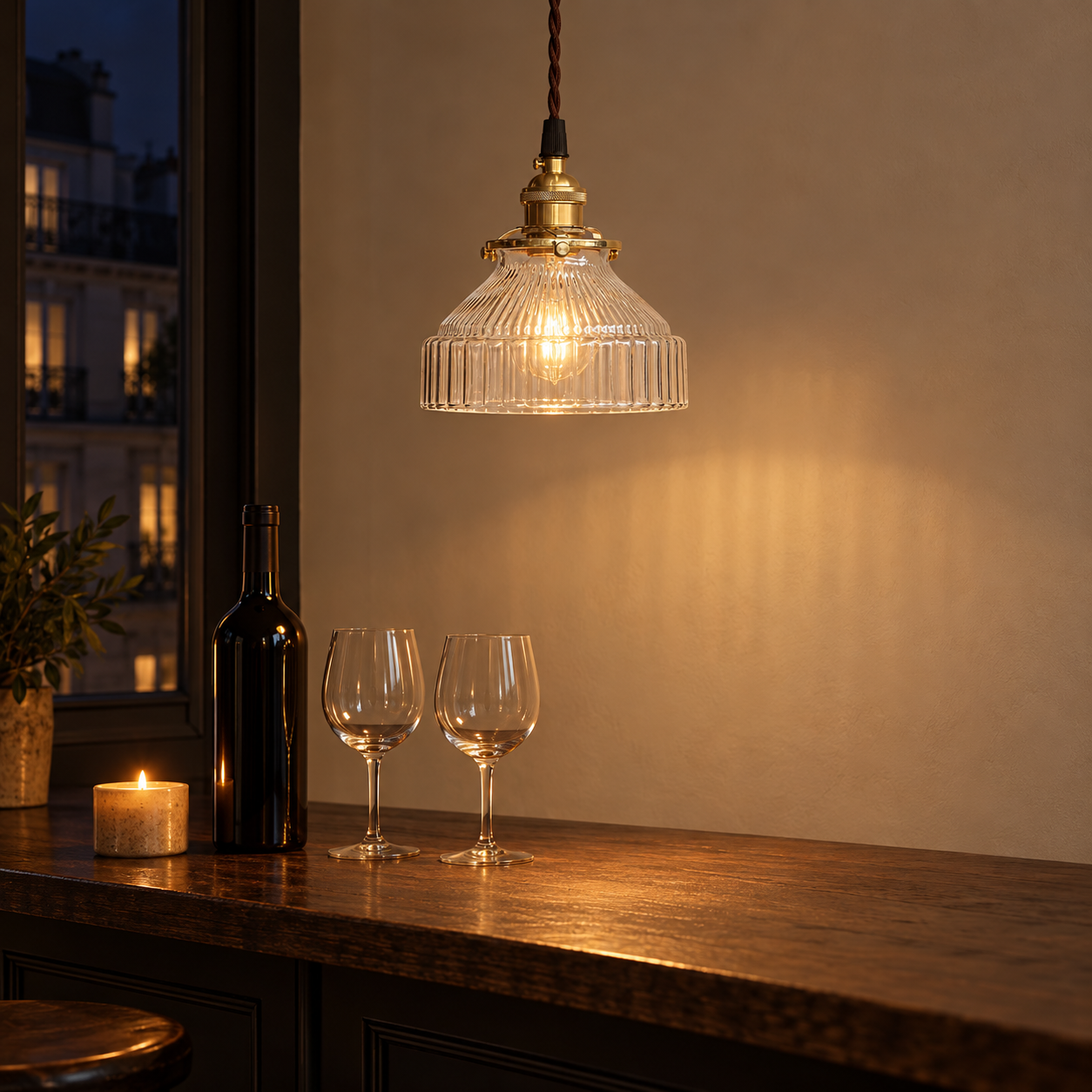 Transparent ribbed glass and brass pendant over a bar